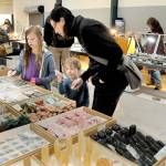 Christine Rose of Port Angeles and her children, Eliabeth Poindexter, 8, and Rowan Poindexter, 4, examine a display of rocks and crystals at the Clallam County Gem & Mineral Associations Rock, Gem & Jewelry Show on Saturday at Vern Burton Community Center in Port Angeles. The two-day event showcased a wide variety of exhibits and vendors offering crystals, minerals, rocks and gemstones from around the world. (Keith Thorpe/Peninsula Daily News)