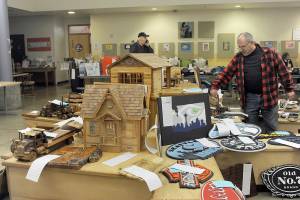 Jon Buonpane of Forks looks over a few of the many wooden items  many made by Olympic Corrections Center inmates  featured during the 2023 Quillayute Valley Scholarship Auction on Saturday. The auction, which continued on Sunday, offered more than 1,000 items to raise money for scholarships for Forks High School graduates. The annual event was accompanied this year by the inaugural Forever Twilight in Forks Equinox, which ran from Friday through Sunday. (Lonnie Archibald/for Peninsula Daily News)