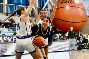 Peninsulas Itaua Tuisaula battles through a Lane double team during the NWAC semifinals held Saturday in Pasco. Tuisaula had 14 points, 15 rebounds and four blocks before leaving the game with an ankle injury. (Jay Cline/Peninsula College)