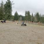 Peninsula Junior Rodeo competitors Lillian Bond and Jasper practice Breakaway Roping (meaning she releases the rope after she throws the loop around the steers head instead it staying attached to her saddle horn and backing up to keep a tight connection between horse and steer)) using a dummy steer pulled by a Quad driven by her mom Jennifer Bond. (Karen Griffiths/For Peninsula Daily News)