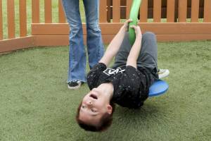 Maxamus White, 8, laughs with delight as his mother, Naomi White of Port Angeles, twirls him around on a spin toy on Saturday at the Dream Playground at Erickson Playfield in Port Angeles. The pair were enjoying a break in the weather before showers moved into the area. (Keith Thorpe/Peninsula Daily News)