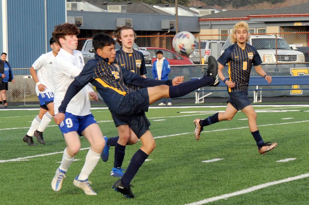 Lonnie Archibald/for Peninsula Daily News
Forks Jorge Diaz kicks back over his head towards the Forks goal while teammates Brody Owen and DeAnthony Davila, right, look on. Also in the action are Elmas Matthew Wood, left, and Theo Flores.