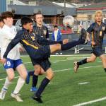 Spartan Jorge Diaz kicks back over his head towards the Forks goal while teammates Brody Owen and DeAnthony  Davila (8) look on.  Also in the action are Elma's Matthew Wood (9) and Theo Flores (10).  Photo by Lonnie Archibald.