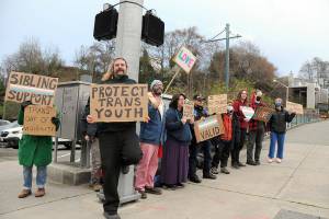 People gather at First and Lincoln streets in Port Angeles on Friday in support of transgender rights. The group was celebrating the International Transgender Day of Visibility, an annual event celebrating transgender people and raising awareness of discrimination they can face. (Keith Thorpe/Peninsula Daily News)