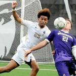KEITH THORPE/PENINSULA DAILY NEWS
Peninsula's Taffel McCootie, left, and the University of Washington's Charlie Kosakoff compete for a loose ball on Saturday at Sigmar Field in Port Angeles.