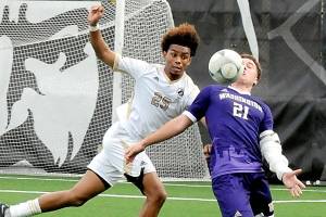 KEITH THORPE/PENINSULA DAILY NEWS
Peninsula's Taffel McCootie, left, and the University of Washington's Charlie Kosakoff compete for a loose ball on Saturday at Sigmar Field in Port Angeles.