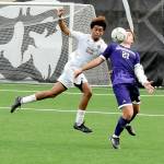Peninsulas Taffel McCootie, left, and the University of Washingtons Charlie Kosakoff compete for a loose ball on Saturday at Sigmar Field in Port Angeles. (Keith Thorpe/Peninsula Daily News)