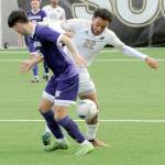 Peninsulas Jem Ndja, right, tries to wrestle the ball away from University of Washingtons Sean Sent during Saturdays exhibition match at Wally Sigmar Field in Port Angeles. (Keith Thorpe/Peninsula Daily News)