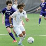 Peninsulas Abdurahim Leigh, center, evades the defense of the University of Washingtons Jack Maguire on Saturday in Port Angeles. (Keith Thorpe/Peninsula Daily News)