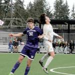 The University of Washingtons Keegan Yorke, left, and Peninsulas Inchun Han compete for a header on Saturday in Port Angeles. (Keith Thorpe/Peninsula Daily News)