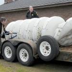 KEITH THORPE/PENINSULA DAILY NEWS
Clallam County Undersheriff Ron Cameron, left, and Patrol Sgt. John Keegan secure a crumpled tsunami siren to a trailer on Friday after it was toppled from its support pole on Marine Drive in Port Angeles by a traffic crash early Friday morning.