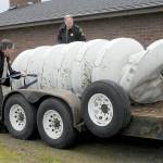 Clallam County Undersheriff Ron Cameron, left, and Patrol Sgt. John Keegan secure a crumpled tsunami siren to a trailer on Friday after it was toppled from its support pole on Marine Drive in Port Angeles by a traffic crash early Friday morning. (KEITH THORPE/PENINSULA DAILY NEWS)