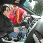 Cheri Tinker, executive director of Forks-based Sarges Veterans Support, front, looks over the features of a donated van with Mark Schildknecht, commandant of Mount Olympus Detatchmet 897 of the Marine Corps League after turning over the keys on Thursday at the Northwest Veterans Resource Center in Port Angeles. (KEITH THORPE/PENINSULA DAILY NEWS)
