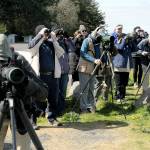 Bird watchers peer out over the waters of Dungeness Bay from Dungeness Landing County Park north of Sequim on Friday in search of waterfowl as part of Olympic BirdFest 2023. The annual birding event draws avian enthusiasts from across the region who are attracted by the diversity of birds across the North Olympic Peninsula. (KEITH THORPE/PENINSULA DAILY NEWS)
