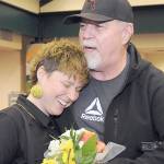 Jaiden Dokken, Clallam Countys first poet laureate, receives a hug and flowers from their father Mark Dokken of Port Angeles after Jaiden was inaugurated to their two-year post on Tuesday at the Port Angeles Public Library. (Keith Thorpe/Peninsula Daily News)