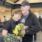 Jaiden Dokken, Clallam Countys first poet laureate, receives a hug and flowers from their father Mark Dokken of Port Angeles after Jaiden was inaugurated to their two-year post on Tuesday at the Port Angeles Public Library. (Keith Thorpe/Peninsula Daily News)