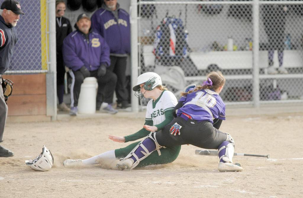 Sequim catcher Mikki Green blocks the plate and applies the tag on Port Angeles baseunner Alexandria Money during the Wolves 7-6 softball win on Tuesday. (Michael Dashiell/Olympic Peninsula News Group)