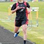 Ryana Moss of Neah Bay checks her time crossing the finish line the girls 1,600-meter run on Wednesday. (Keith Thorpe/Peninsula Daily News)
