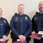Officer Lilliana Emery, Officer Kyle Cooper and Cpl. Jeff Ordona, from left. were recognized by the Port Angeles City Council for their actions in saving a man in a burning car. The three received Life Saving Medals and Meritorious Service Medals.