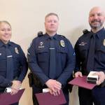Officer Lilliana Emery, Officer Kyle Cooper and Cpl. Jeff Ordona, from left. were recognized by the Port Angeles City Council for their actions in saving a man in a burning car. The three received Life Saving Medals and Meritorious Service Medals.