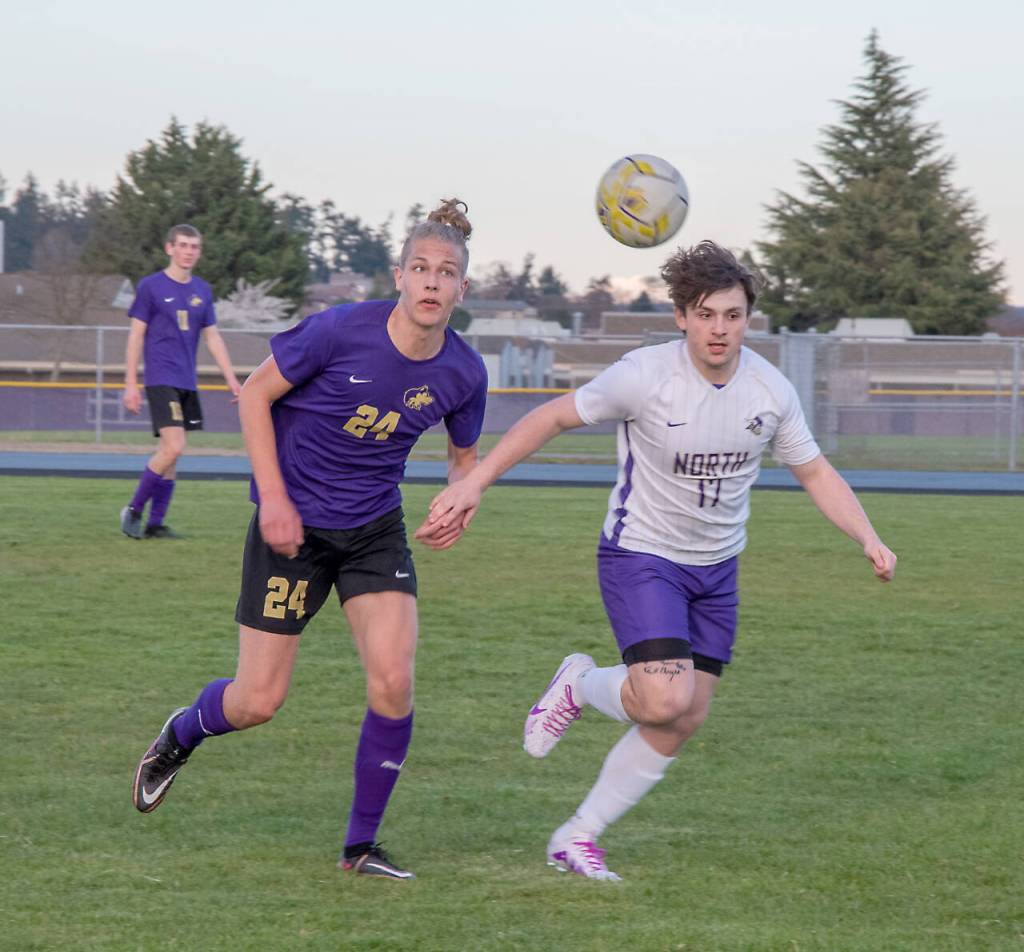 Sequims Jack Henninger (24) and North Kitsaps Trevor Flowers (17) battle for a loose ball Tuesday in Sequim. (Emily Matthiesson/Olympic Peninsula News Group)
