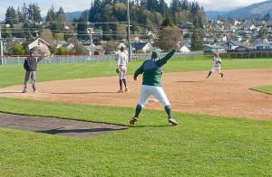 Port Angeles coach Zac Moore waves baserunner Josiah Gooding around third base for a run after a Colton Romero double at Civic Field on Tuesday. Despite a big four-run second inning, Bainbridge beat Port Angeles 13-3. (Pierre LaBossiere/Peninsula Daily News)