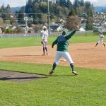 Port Angeles coach Zac Moore waves baserunner Josiah Gooding around third base for a run after a Colton Romero double at Civic Field on Tuesday. Despite a big four-run second inning, Bainbridge beat Port Angeles 13-3. (Pierre LaBossiere/Peninsula Daily News)