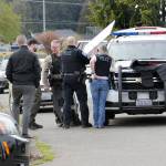 Port Angeles police and Clallam County Sheriffs deputies gather at the scene of a standoff that forced closure of the 1100 block of East Third Street on Wednesday afternoon. (Keith Thorpe/Peninsula Daily News)