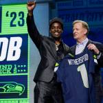 Illinois defensive back Devon Witherspoon, left, stands with NFL Commissioner Roger Goodell after being chosen by the Seattle Seahawks with the fifth overall pick during the first round of the NFL football draft, Thursday, April 27, 2023, in Kansas City, Mo. (AP Photo/Jeff Roberson)