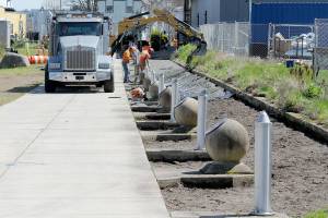 KEITH THORPE/PENINSULA DAILY NEWS
A construction crew performs landscape work along a portion of the Waterfront Trail, part of the Olympic Discovery Trail, at Pebble Beach Park on Friday near downtown Port Angeles. As part of the project, vegetation along the trail was removed for trail upkeep and beautification. The trail through the park was closed during the work, but was scheduled to be reopened by today.