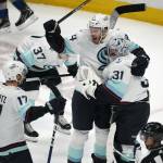 From left, Seattle Kraken center Jaden Schwartz, defenseman Jamie Oleksiak and goaltender Philipp Grubauer celebrate as time runs out in the third period of Game 7 of an NHL first-round playoff series against the Colorado Avalanche Sunday, April 30, 2023, in Denver. The Kraken won 2-1 to advance to round two of the Stanley Cup Playoffs against the Dallas Stars. (AP Photo/David Zalubowski)