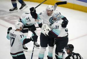 From left, Seattle Kraken center Jaden Schwartz, defenseman Jamie Oleksiak and goaltender Philipp Grubauer celebrate as time runs out in the third period of Game 7 of an NHL first-round playoff series against the Colorado Avalanche Sunday, April 30, 2023, in Denver. The Kraken won 2-1 to advance to round two of the Stanley Cup Playoffs against the Dallas Stars. (AP Photo/David Zalubowski)