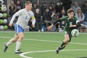 KEITH THORPE/PENINSULA DAILY NEWS
Port Angeles' Keane McClain, right, chases a loose ball as Bremerton's Brennan Galloway closes in on Thursday night in Port Angeles.
