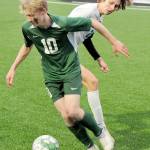 KEITH THORPE/PENINSULA DAILY NEWS Port Angeles Matthew Miller, front, slips past Bremertons Evan Falk during Thursdays match at Peninsula College.