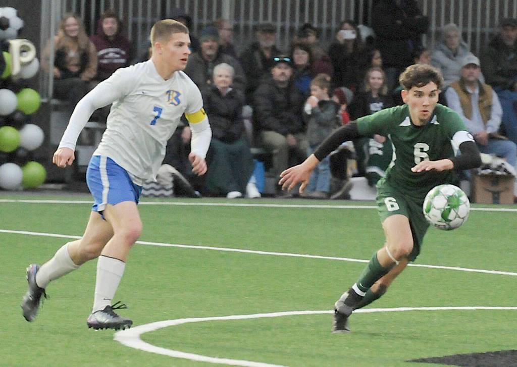 KEITH THORPE/PENINSULA DAILY NEWS Port Angeles Keane McClain, right, chases a loose ball as Bremertons Brennan Galloway closes in on Thursday night in Port Angeles.