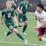 KEITH THORPE/PENINSULA DAILY NEWS
Port Angeles' Matthew Miller, left, chases a loose ball ahead of Kingston's Edwin Vallecillo, right, as Miller's teammates, from left, Hannes Spieker, Kaleb Gagnon and Jacob Miller watch from the backfield during Saturday's match in Port Angeles.