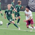 Port Angeles Matthew Miller, left, chases a loose ball ahead of Kingstons Edwin Vallecillo, right, as Millers teammates, from left, Hannes Spieker, Kaleb Gagnon and Jacob Miller watch from the backfield during Saturdays match in Port Angeles. (Keith Thorpe/Peninsula Daily News)