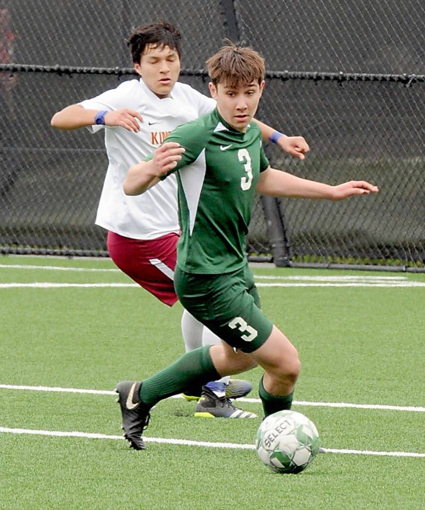 Port Angeles Landon Close, steps ahead of Kingstons Alvaro Anglas-Camerana on Saturday at Peninsula College. (Keith Thorpe/Peninsula Daily News)