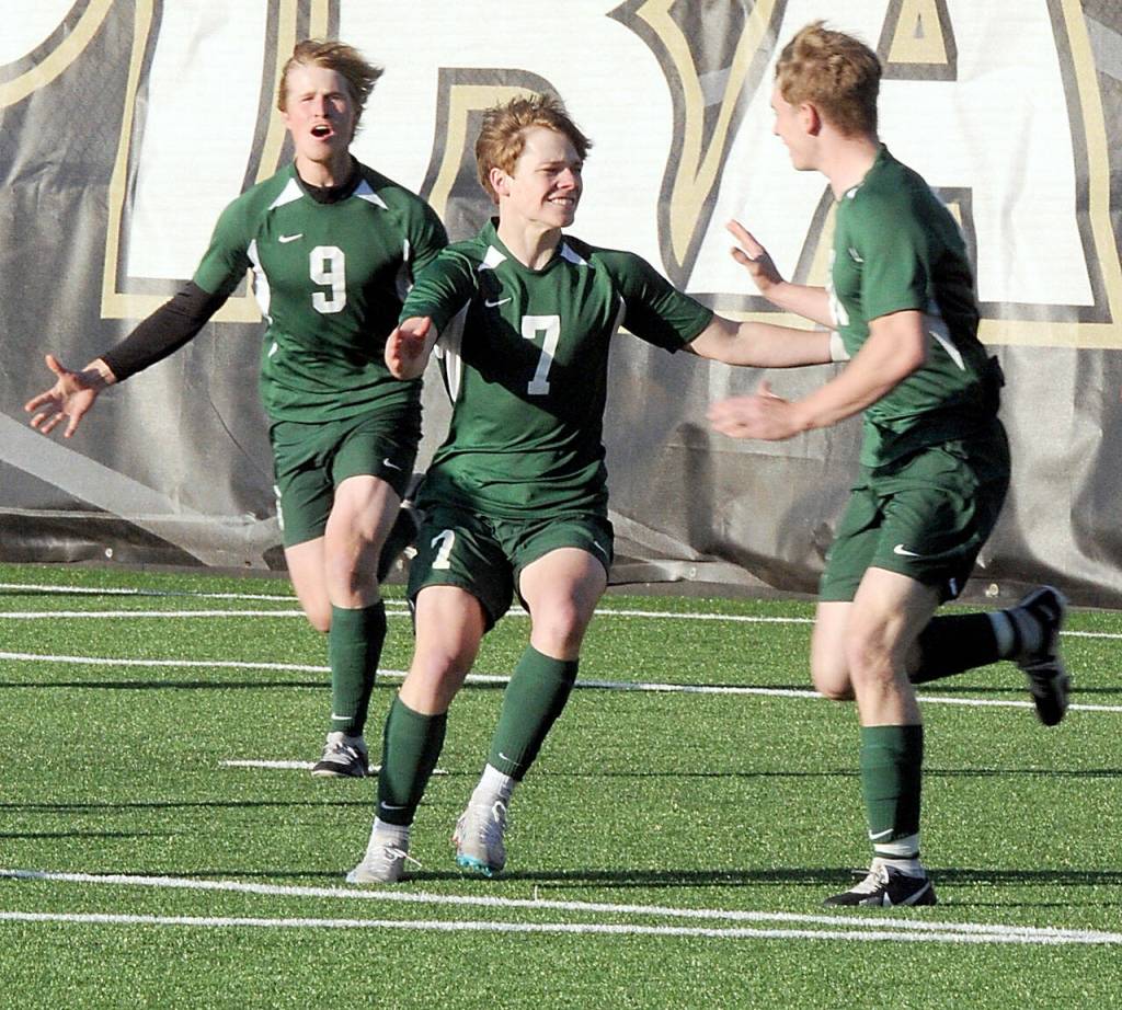 Port Angeles Caleb Gagnon, center, is congratulated by teammates Hannes Speiker, left, and Josiah Long, right, after Gagnon scored a first-half goal against Highline on Tuesday at Peninsula College. (Keith Thorpe/Peninsula Daily News)