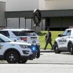 An armed Clallam County sheriffs deputy walks near the entrance of Port Angeles High School after a telephone threat was made to the school on Thursday. (Keith Thorpe/Peninsula Daily News)