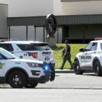An armed Clallam County sheriffs deputy walks near the entrance of Port Angeles High School after a telephone threat was made to the school on Thursday. (Keith Thorpe/Peninsula Daily News)
