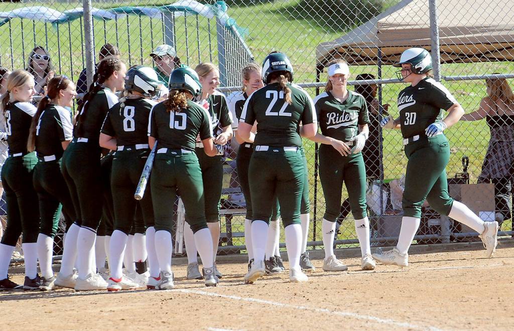 Port Angeles Abby Kimball, right, reaches the plate surrounded by her teammates after batting a two-run homer in the fifth inning against Sequim on Friday at Dry Creek Elementary in Port Angeles. (Keith Thorpe/Peninsula Daily News)