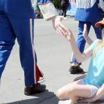 Ruth Scheett, 9, along with her brother, Paul Scheett, 11, behind, both of Sequim, get low-fives from passing members of the Chimacum High School marching band during Saturdays Irrigation Festival Grand Parade. (Keith Thorpe/Peninsula Daily News)
