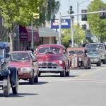 A procession of vintage and antique cars makes its way down Washington Avenue as part of the Irrigation Festival Classic Cruise & Show car show on Saturday. (Keith Thorpe/Peninsula Daily News)