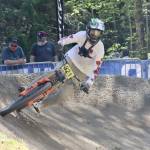 Cullen Ren of Burnaby, B.C. flies around the last banked corner before the finish on the downhill race course for the Northwest Cup on Dry Hill west of Port Angeles on Sunday. Cullen, 20, was racing in the K2 class. More than 500 bike riders came out to the course on Saturday and Sunday for the second race of the Northwest Cup. For results and more photos, look in Tuesdays Peninsula Daily News sports section.