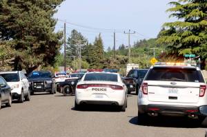Law enforcement agencies respond Tuesday afternoon to a standoff at Lopez Avenue and Vine Street in Port Angeles. (Dave Logan/for Peninsula Daily News)