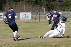 Lonnie Archibald/for Peninsula Daily News
Forks' Keira Johnson slides in safely with a steal of second base during the Spartans' doubleheader with Pe Ell on Wednesday at Tillicum Park in Forks.