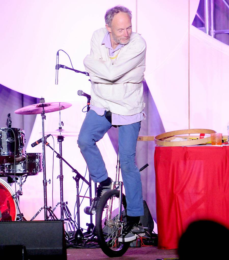 Seattle-based physical comedian Henrik Bothe rides a unicycle while escaping from a straight jacket during his Saturday performance at the Juan de Fuca Festival. (Keith Thorpe/Peninsula Daily News)
