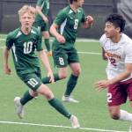 Port Angeles Matthew Miller, left, chases a loose ball ahead of Kingstons Edwin Vallecillo, right in a match this season in Port Angeles. (Keith Thorpe/Peninsula Daily News)