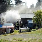 Smoke billows from a garage 71 S. Benson Road near Port Angeles on Wednesday. (Keith Thorpe/Peninsula Daily News)